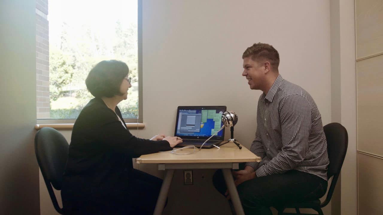 An audiologist working with a patient