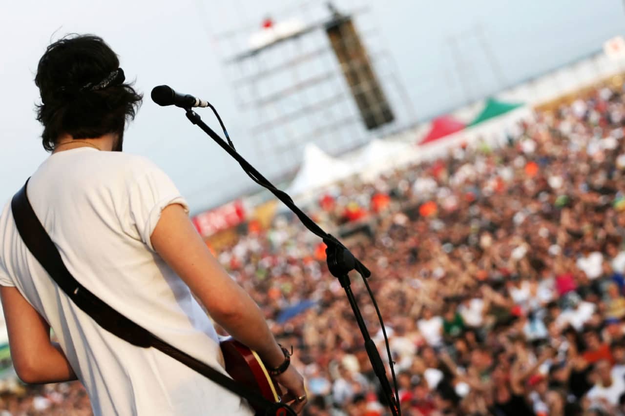 A musician performing for a large crowd